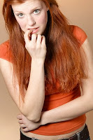 Woman with red hair, orange shirt.