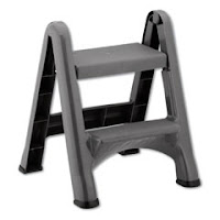 Black plastic folding step stool.