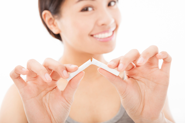 A woman breaking a cigarette.