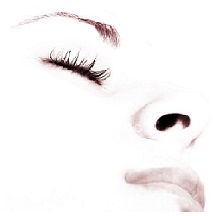 Close-up of a peaceful face with closed eyes and long eyelashes.